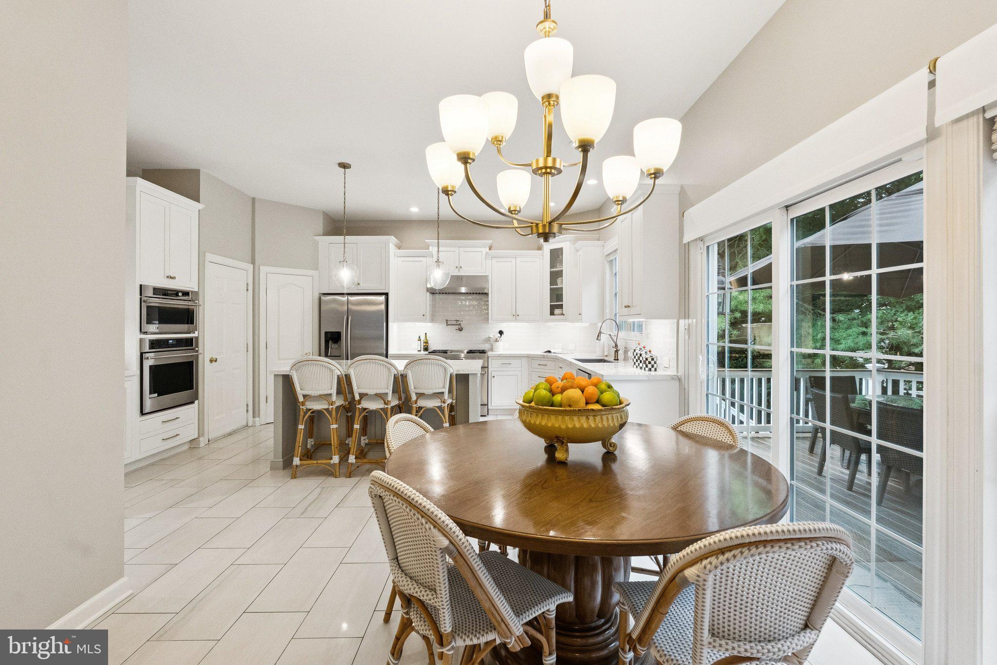 503 Autumn Wind Way Rockville, MD 20850 - Photo 16 of 83 a view of a dining room with furniture a chandelier and large windows