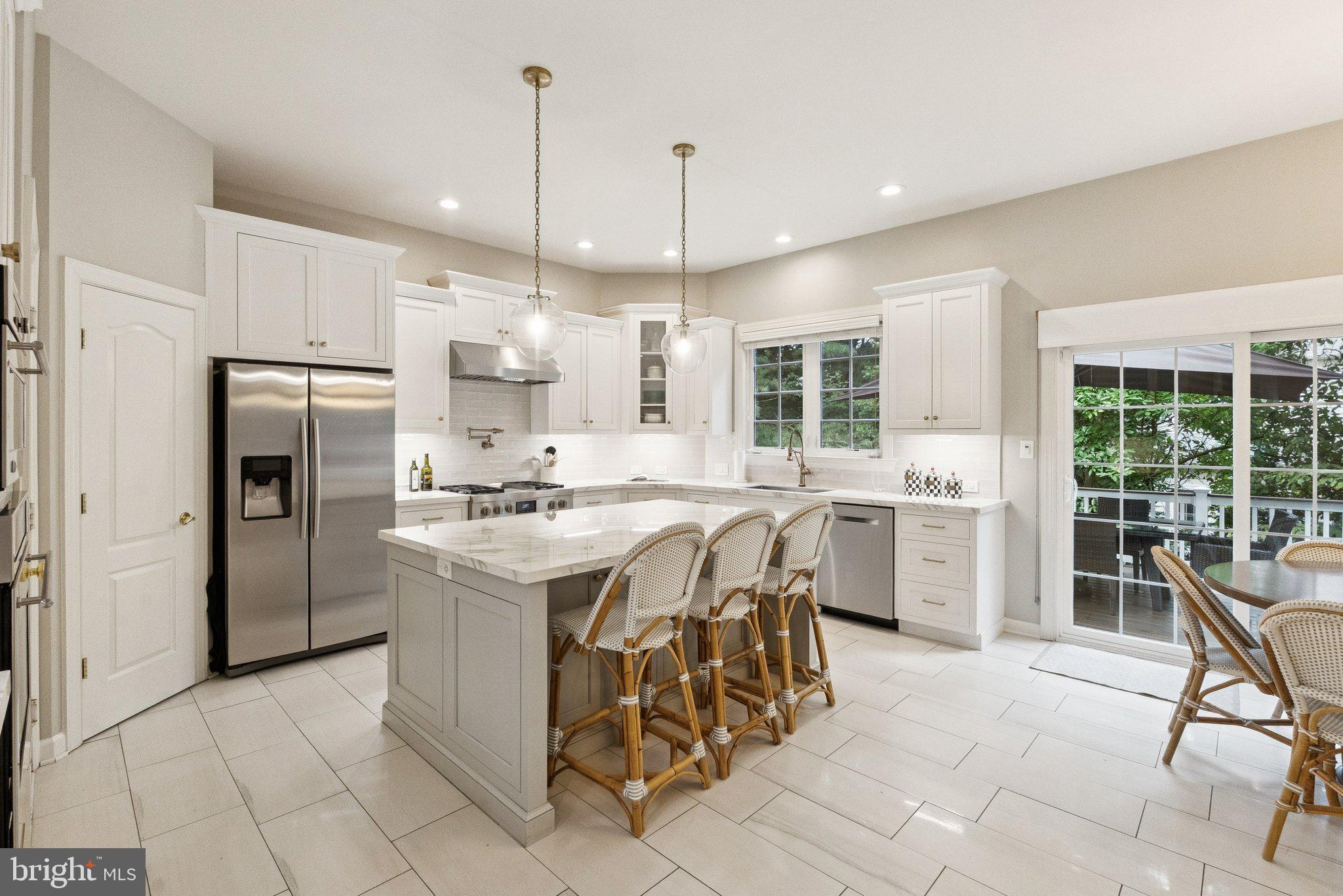 503 Autumn Wind Way Rockville, MD 20850 - Photo 17 of 83 a kitchen with stainless steel appliances kitchen island granite countertop a stove a refrigerator a oven a sink a dining table and chairs with wooden floor