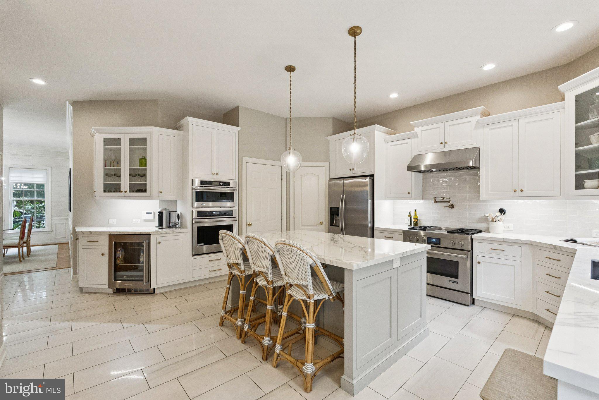 503 Autumn Wind Way Rockville, MD 20850 - Photo 19 of 83 a large kitchen with kitchen island a stove a sink a center island a table and chairs