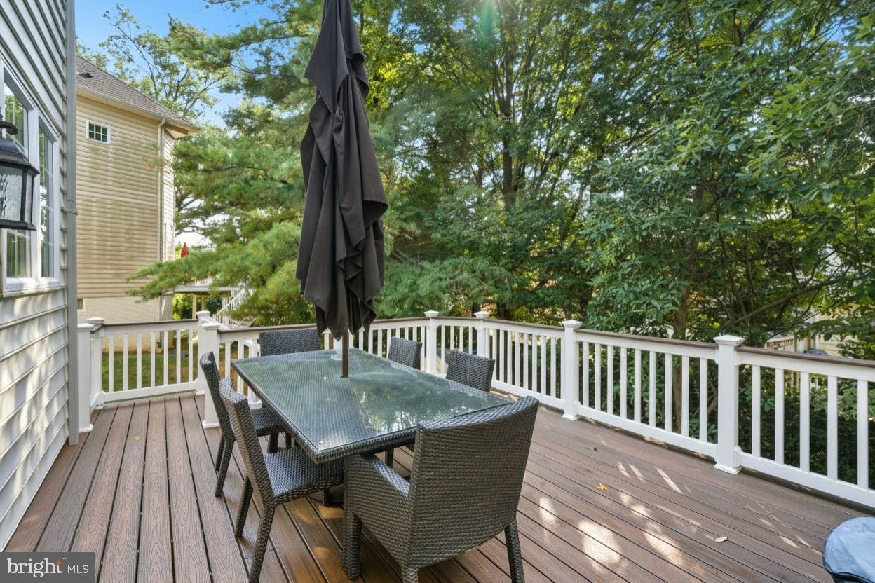 503 Autumn Wind Way Rockville, MD 20850 - Photo 53 of 83 a view of a deck with a table and chairs with wooden floor
