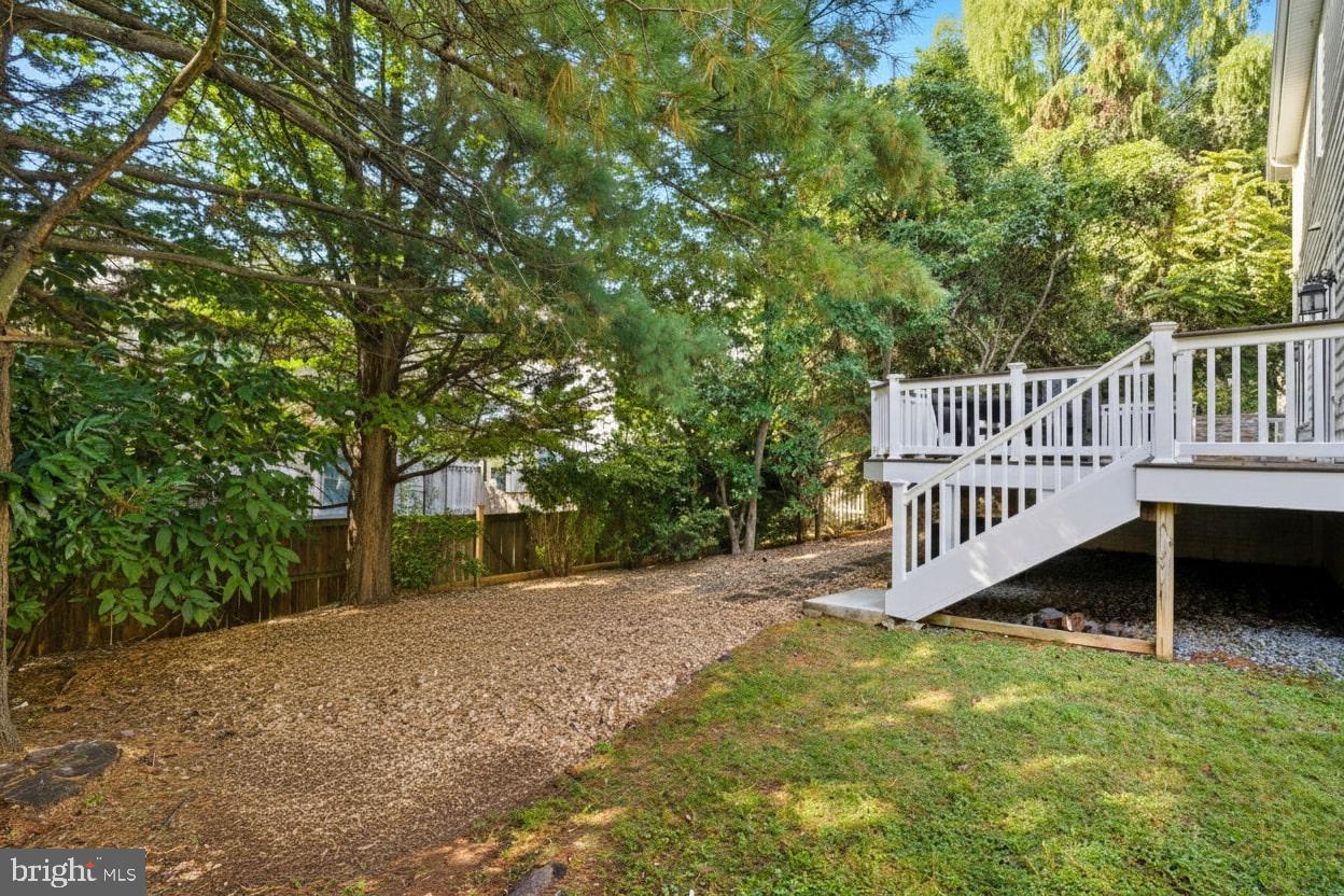 503 Autumn Wind Way Rockville, MD 20850 - Photo 58 of 83 a view of a deck with a big yard and large trees