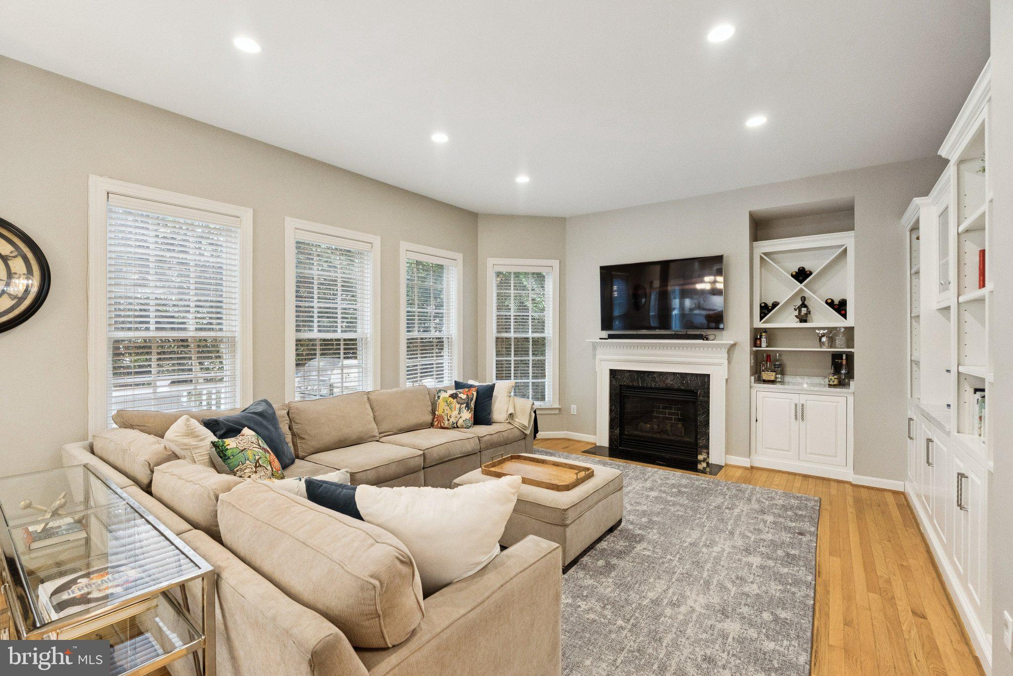 503 Autumn Wind Way Rockville, MD 20850 - Photo 10 of 83 a living room with furniture a fireplace and a flat screen tv