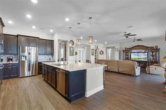 a spacious bedroom with a bed and a chandelier
