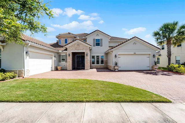 a front view of a house with a garden and yard