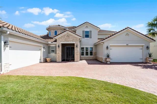 a view of a house with a yard and garage