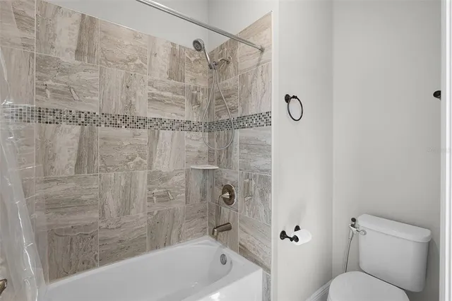 a spacious bedroom with a bed and a couch