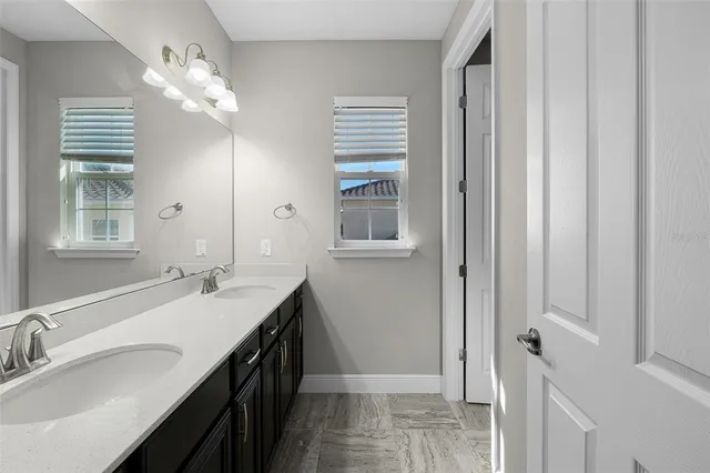 a living room with furniture a flat screen tv and a large window