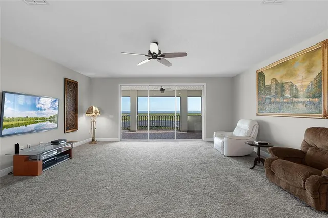 an aerial view of a residential houses with outdoor space and ocean view
