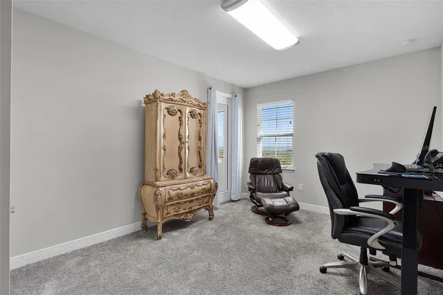an aerial view of residential houses with outdoor space and ocean view