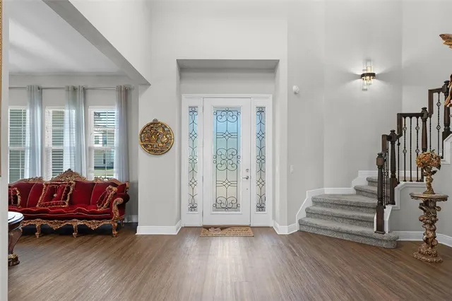 a living room with furniture a wooden floor and a window