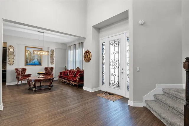 a living room with furniture and wooden floor