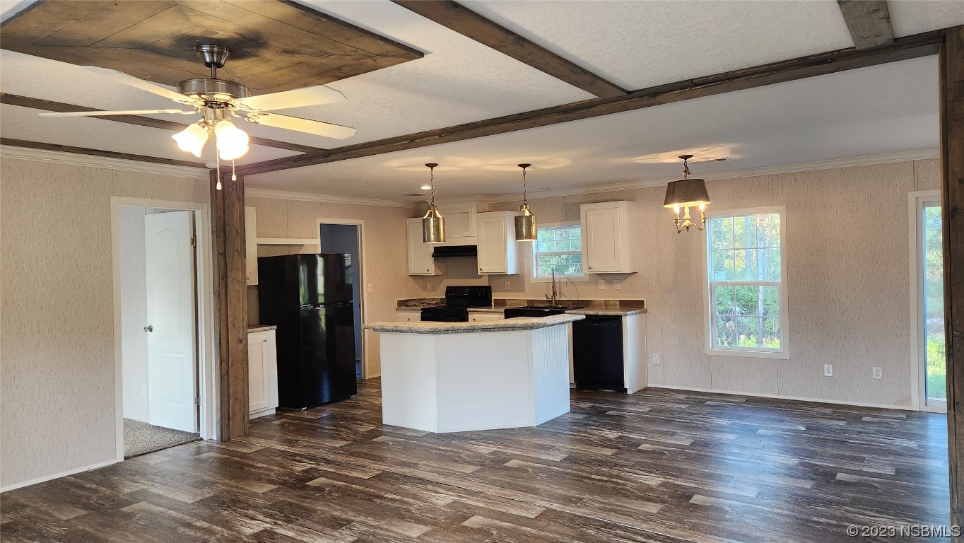 6262 Cherry Lane Bunnell, FL 32110 - Photo 19 of 41 a kitchen with stainless steel appliances kitchen island granite countertop a refrigerator and a sink