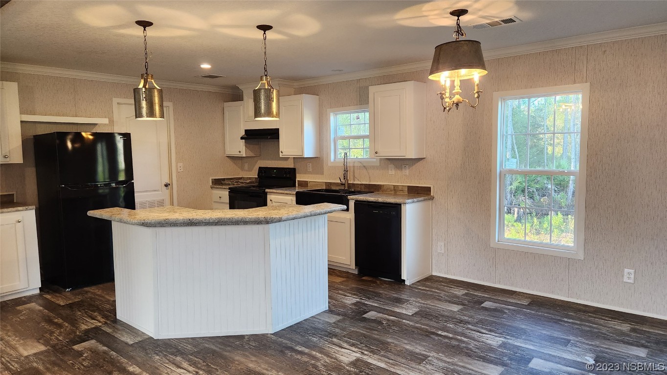 6262 Cherry Lane Bunnell, FL 32110 - Photo 23 of 41 a kitchen with stainless steel appliances granite countertop a refrigerator a sink and a wooden floor