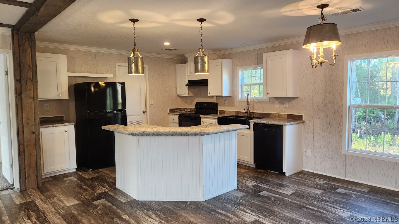 6262 Cherry Lane Bunnell, FL 32110 - Photo 24 of 41 a kitchen with stainless steel appliances granite countertop a refrigerator a sink and a wooden floor