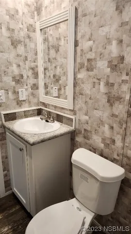 a white toilet sitting next to a bathroom sink