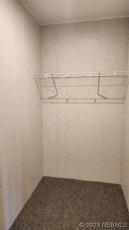 an empty room with closet area