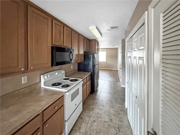 a kitchen with a stove a sink and a refrigerator