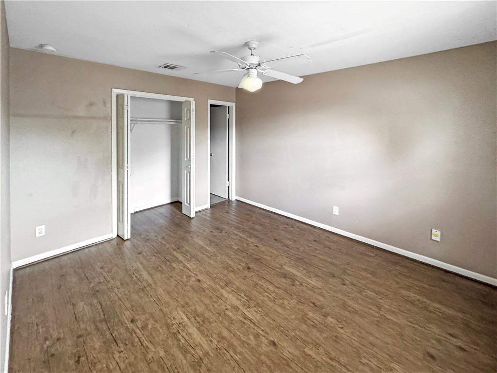 1601 South College Avenue, Unit 5 Bryan, TX 77801 - Photo 4 of 6 wooden floor in an empty room with a window