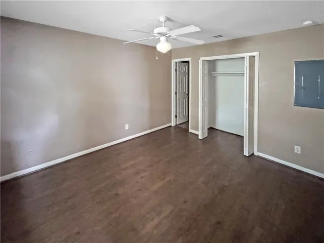 a view of an empty room with a ceiling fan