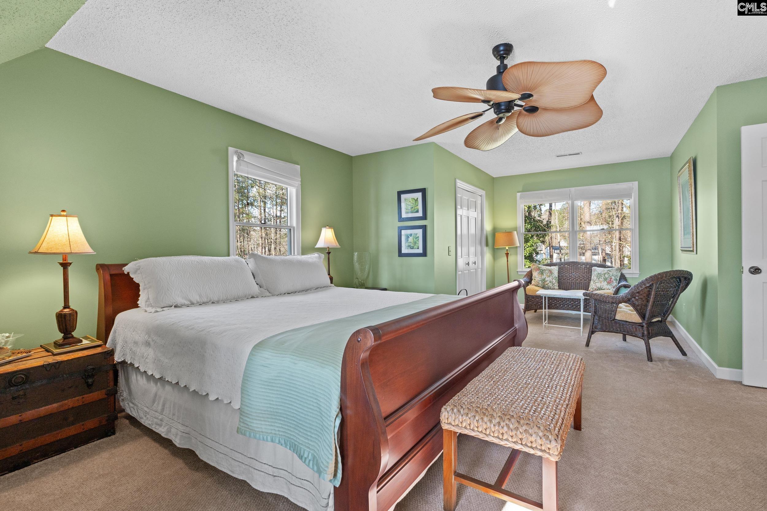115 Rocky Ridge Road Leesville, SC 29070 - Photo 29 of 51 a bed room with a bed and a chair