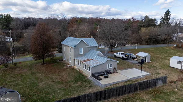 a view of a house with patio and backyard