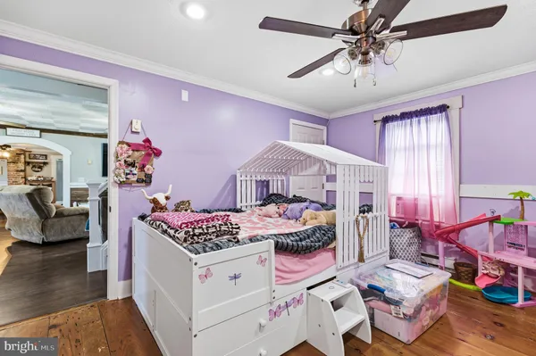 a bedroom with furniture and a wooden floor