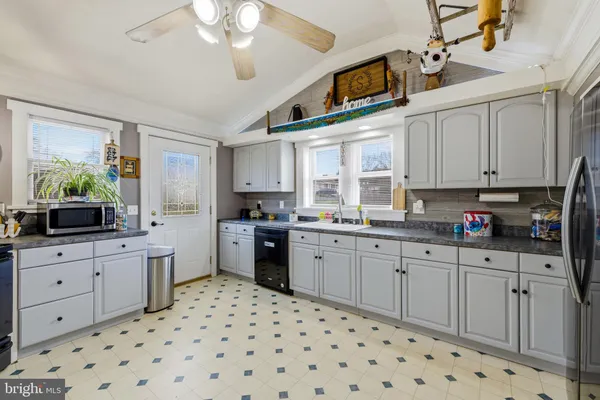 a kitchen with a refrigerator and a sink