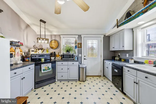 a kitchen with a window and cabinets