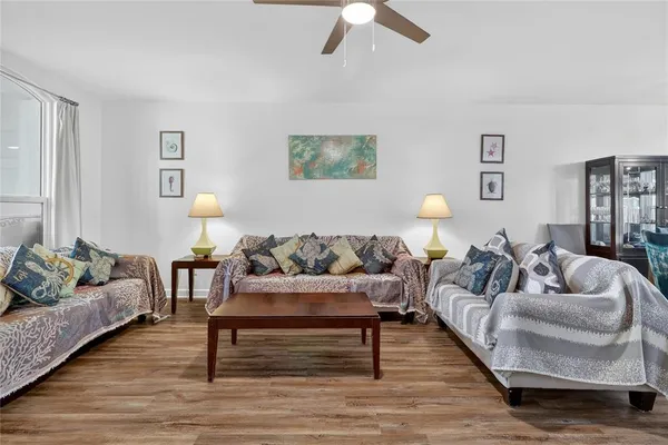 a kitchen with stainless steel appliances granite countertop a table chairs sink and cabinets