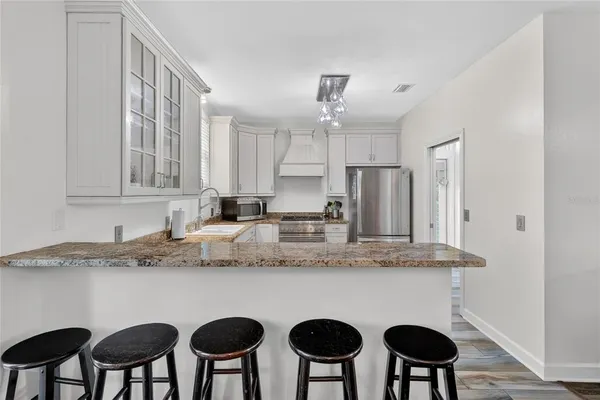 a spacious bathroom with a granite countertop sink and a mirror