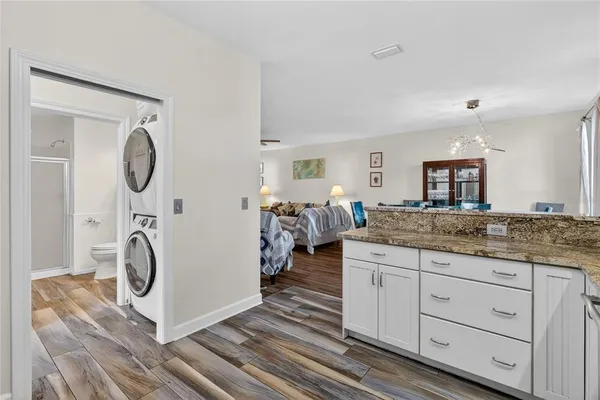 a view of a room with wooden floor and windows