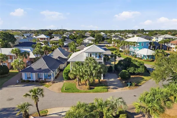 an aerial view of multiple houses with a yard