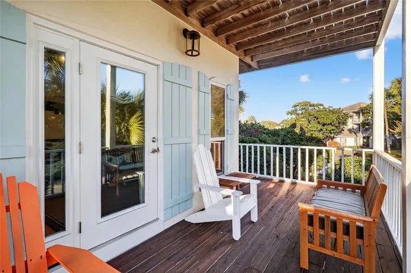 a bedroom with a bed wooden floor and window
