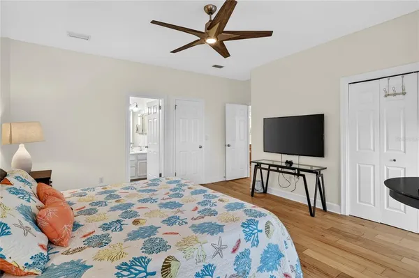 a balcony with wooden floor table and chairs