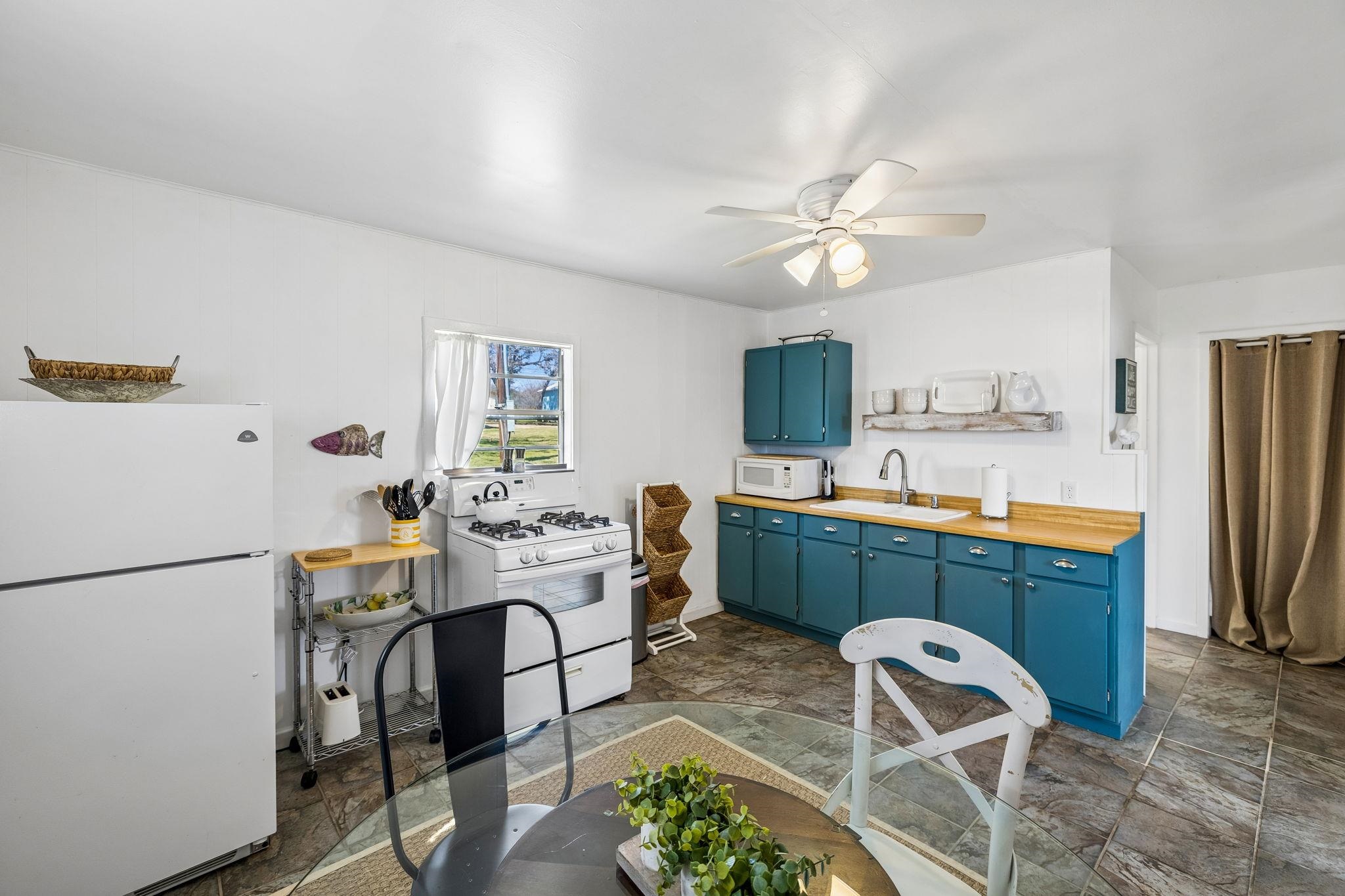16838 Rm 2241 Tow, TX 78672 - Photo 16 of 30 a kitchen with stainless steel appliances a dining table chairs and a refrigerator
