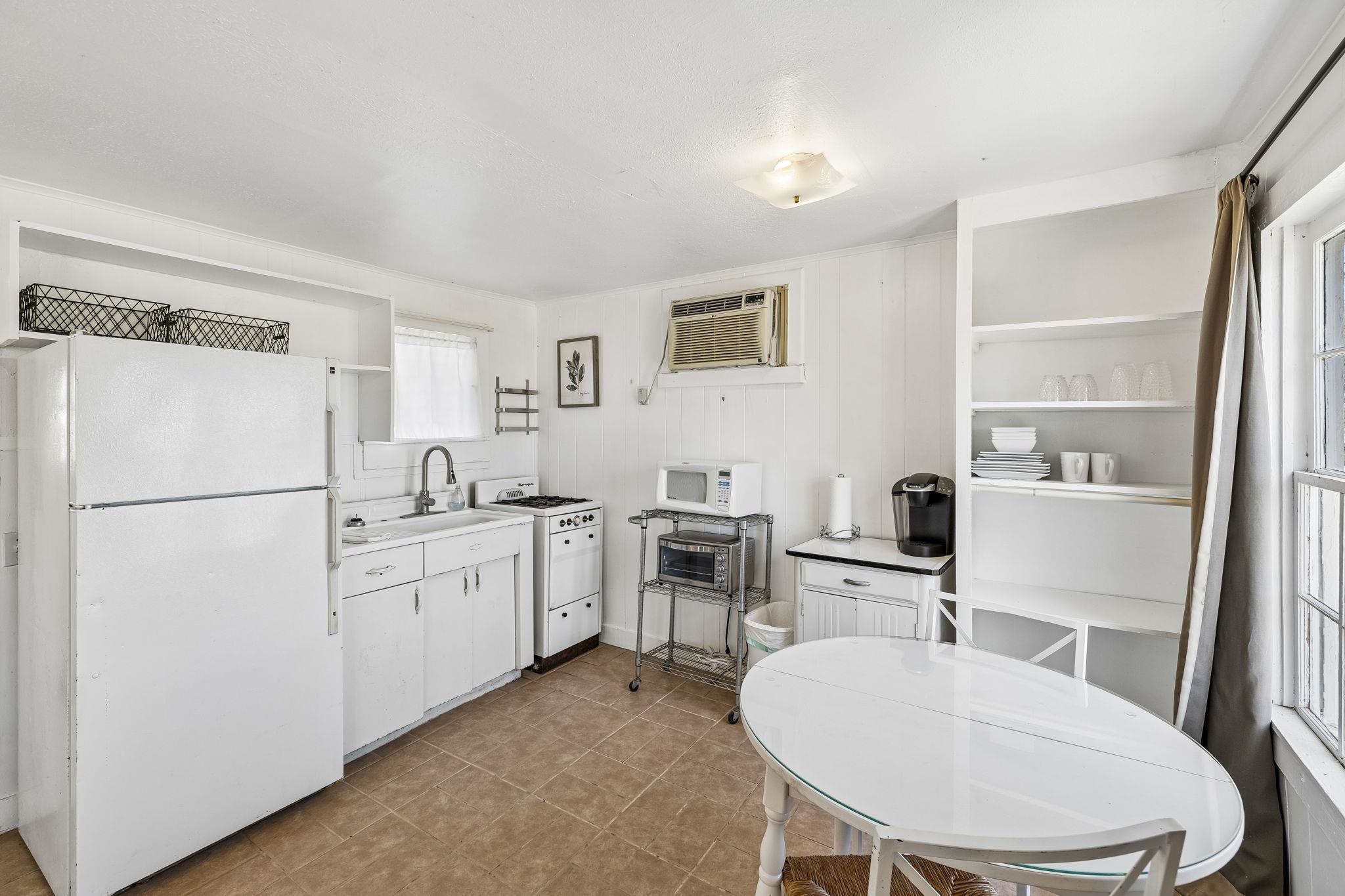 16838 Rm 2241 Tow, TX 78672 - Photo 19 of 30 a kitchen with white cabinets and white appliances