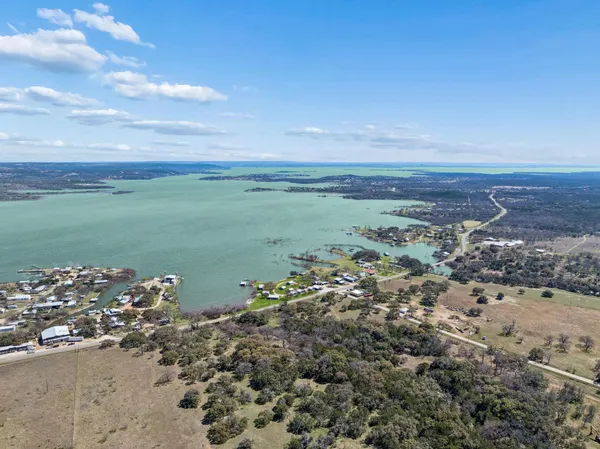 an aerial view of a city with lots of residential buildings lake and ocean view