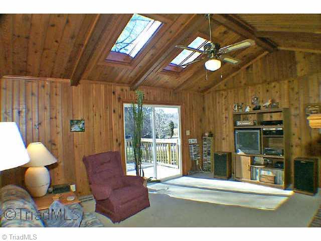 8075 Haw River Road Stokesdale, NC 27310 - Photo 3 of 9 Other. Den showing skylights and view to deck and partially wooded back yard