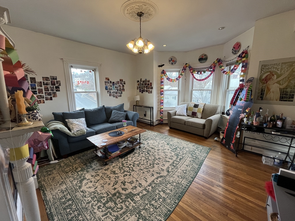 a living room with furniture a rug and a chandelier