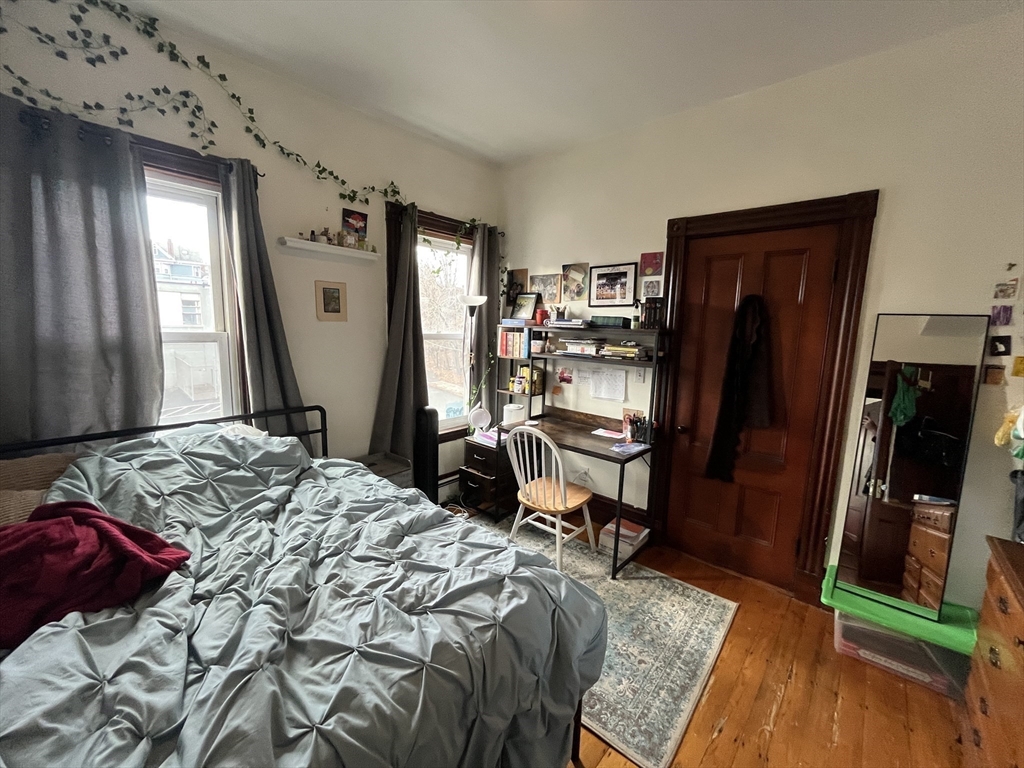 142 St Alphonsus Street, Unit 3 Boston, MA 02120 - Photo 13 of 13 a bedroom with a bed and a dresser in it