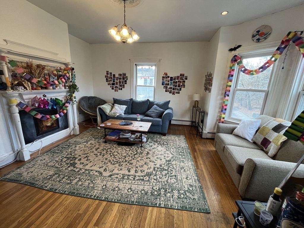 142 St Alphonsus Street, Unit 3 Boston, MA 02120 - Photo 2 of 13 a living room with furniture and a rug