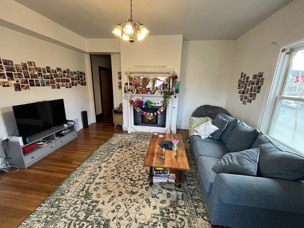 142 St Alphonsus Street, Unit 3 Boston, MA 02120 - Photo 4 of 13 a living room with furniture and a flat screen tv