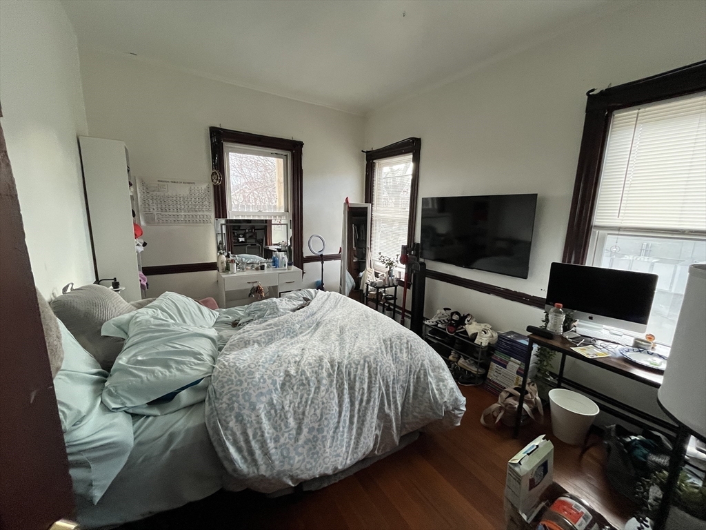 142 St Alphonsus Street, Unit 3 Boston, MA 02120 - Photo 7 of 13 a bedroom with a bed and a flat screen tv