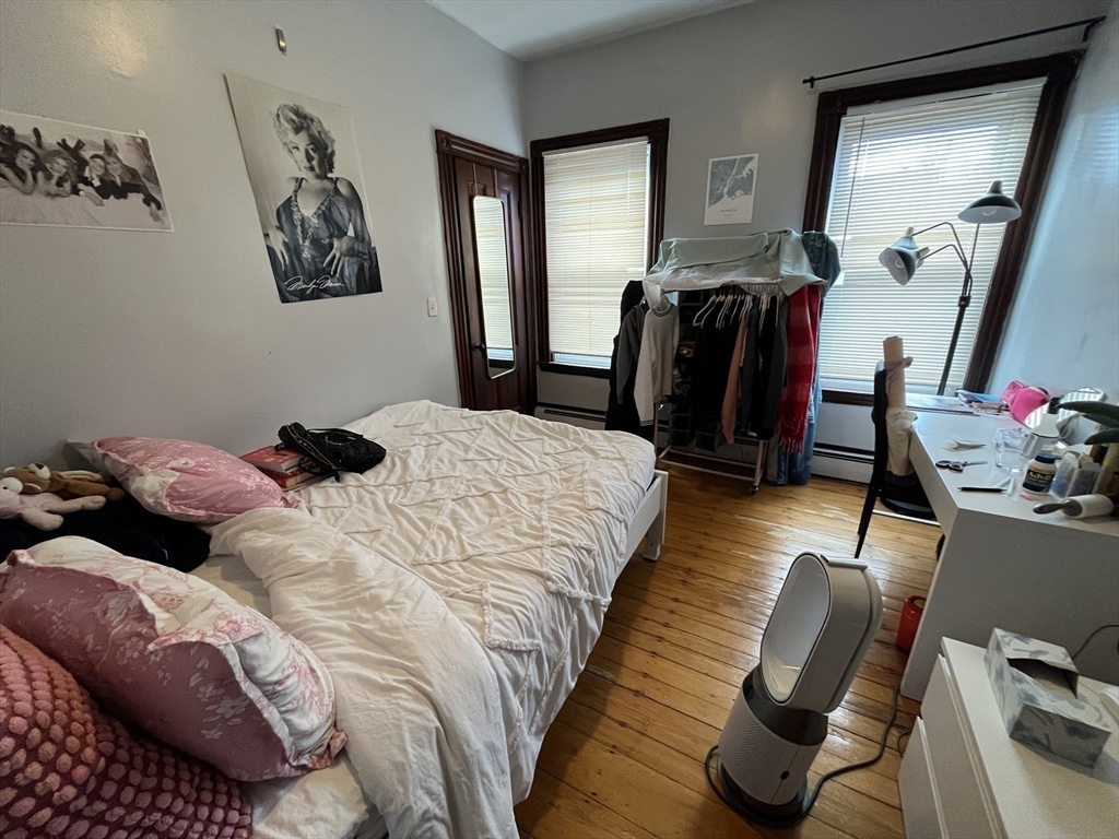 142 St Alphonsus Street, Unit 3 Boston, MA 02120 - Photo 8 of 13 a bedroom with bed and a mirror