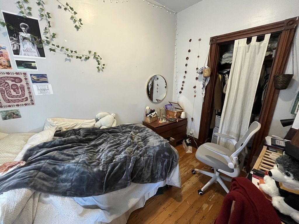 142 St Alphonsus Street, Unit 3 Boston, MA 02120 - Photo 10 of 13 a bedroom with a bed and a mirror on the dresser