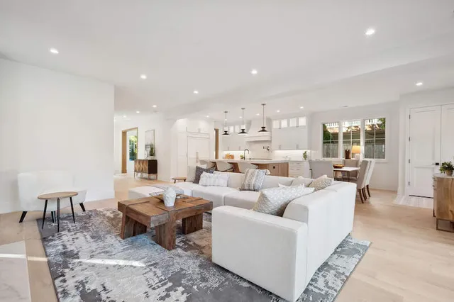 a kitchen with a sink a counter space and a large mirror