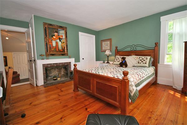 52 Salem Street Andover, MA 01810 - Photo 14 of 21 a bed sitting in a bedroom next to a fireplace