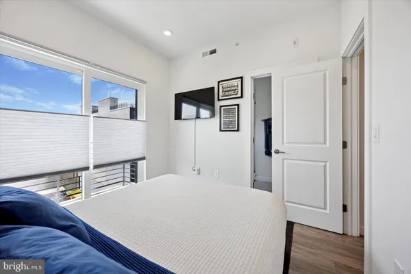 a bedroom with a bed and a night stand