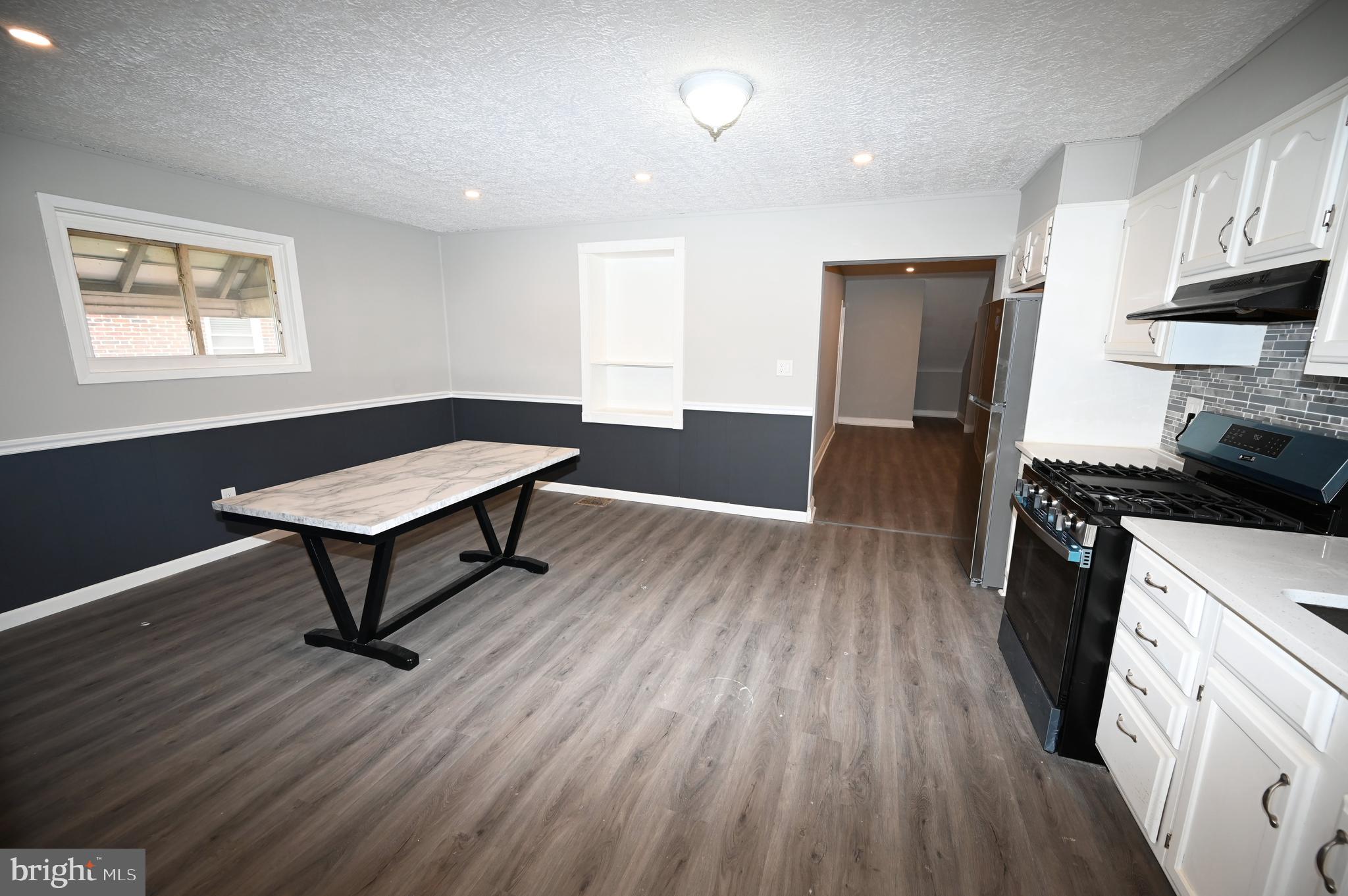 2952 Sollers Point Road, Unit B Dundalk, MD 21222 - Photo 29 of 37 a living room with stainless steel appliances wooden floors and kitchen view