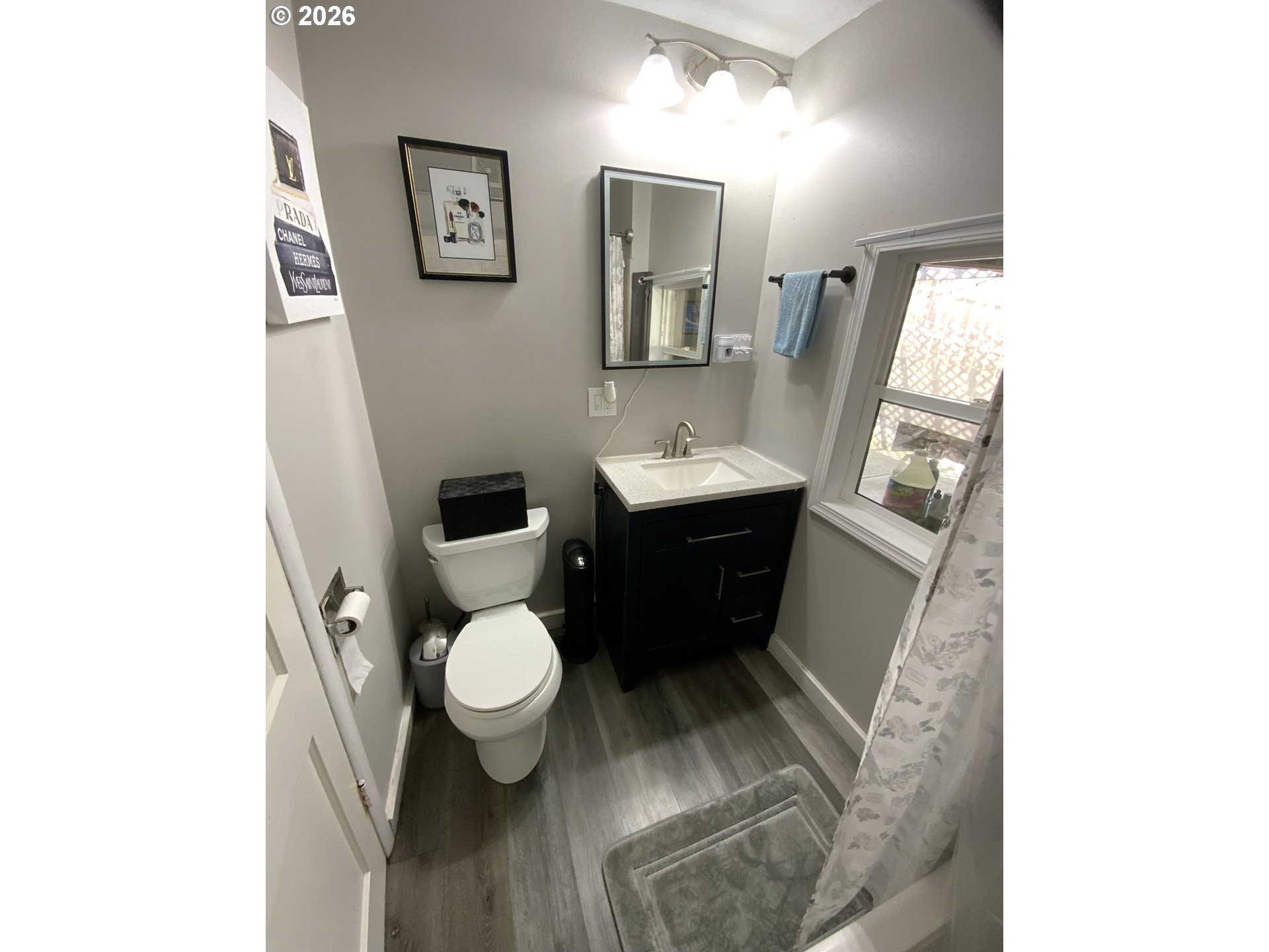 400 West 6th Street The Dalles, OR 97058 - Photo 11 of 28 a bathroom with a toilet sink and mirror